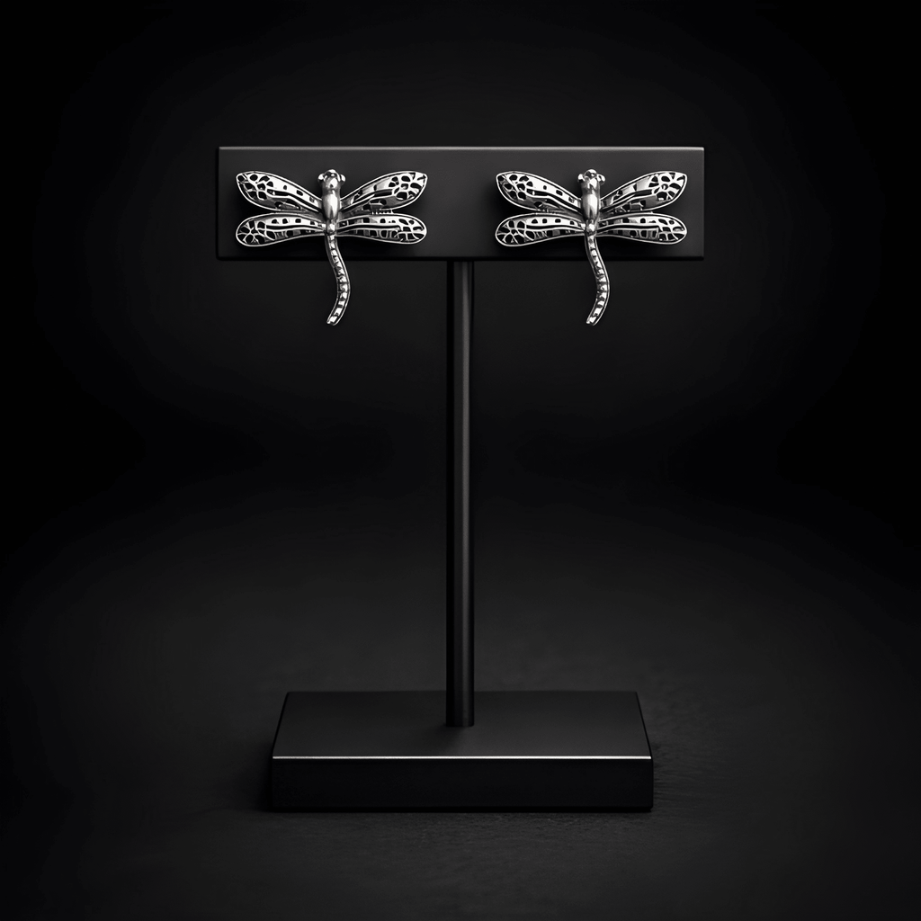Dragonfly stud earrings displayed on black stand
