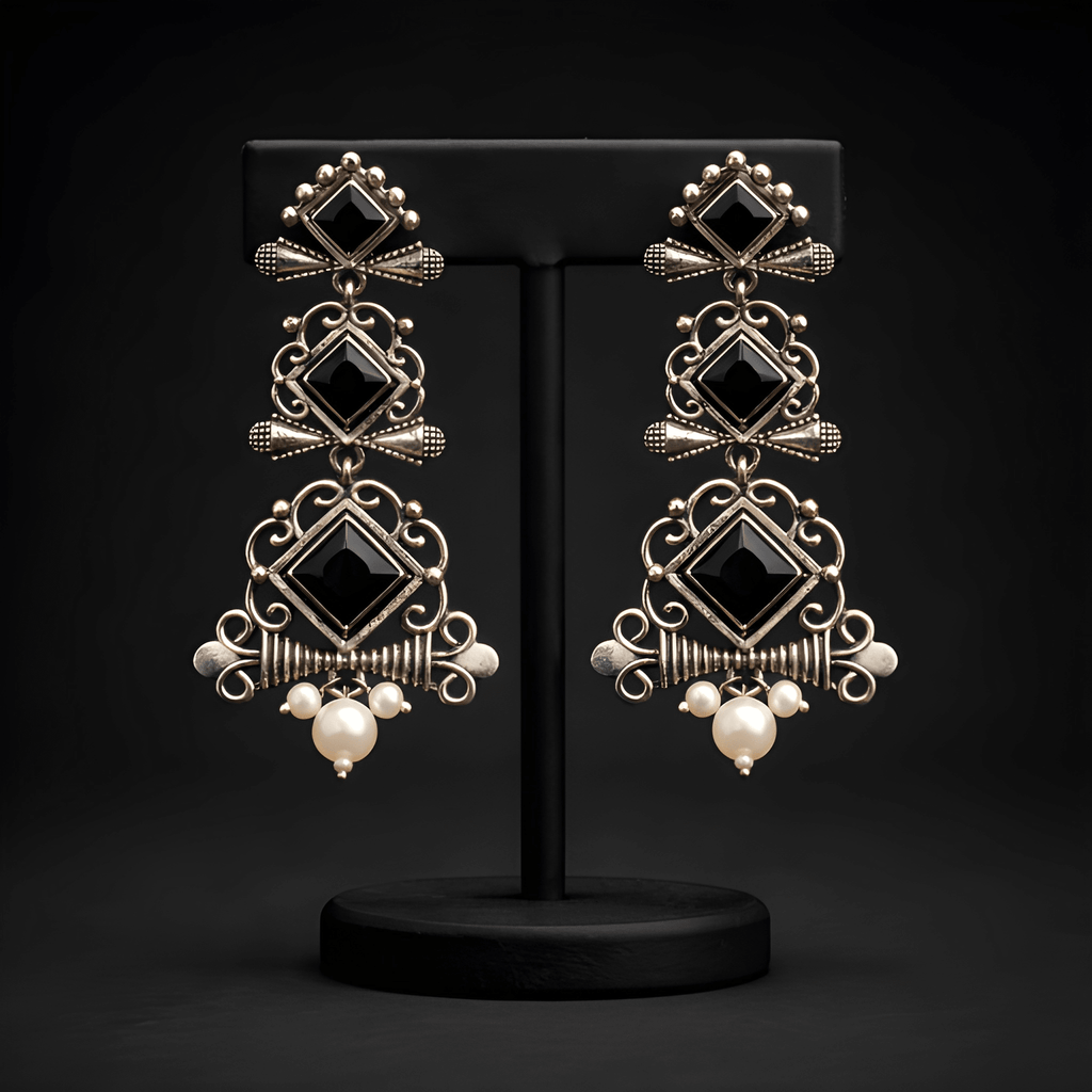 Multi-tier chandelier dangler earrings displayed on black stand
