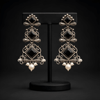 Multi-tier chandelier dangler earrings displayed on black stand
