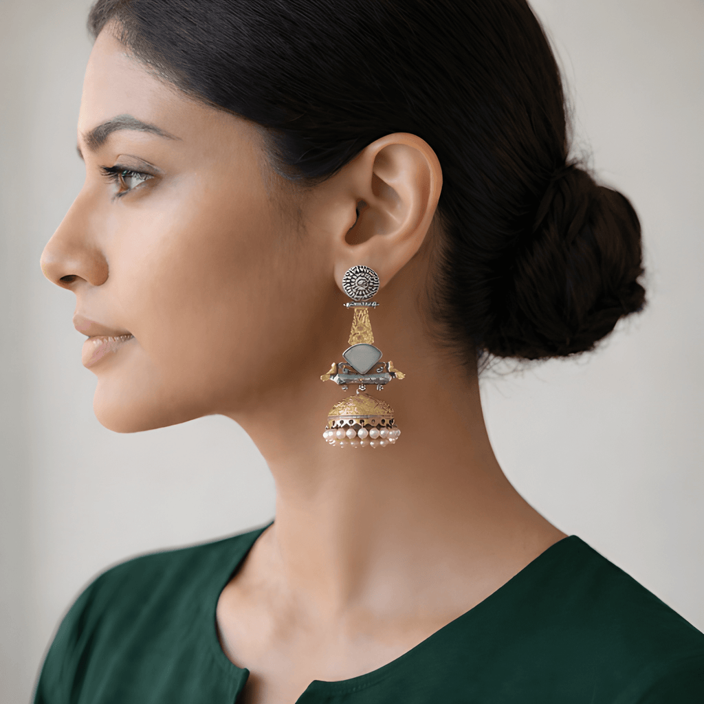 Woman wearing bird motif jhumka dangler earrings with pearl drops
