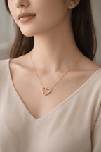 Woman wearing minimal gold heart pendant necklace
