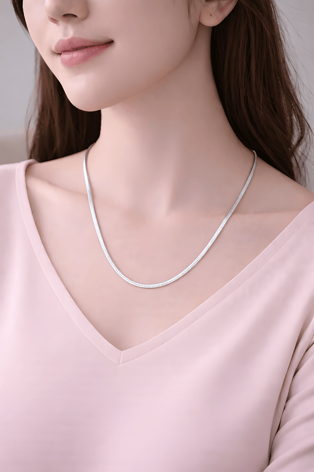 Woman wearing minimal silver snake chain necklace