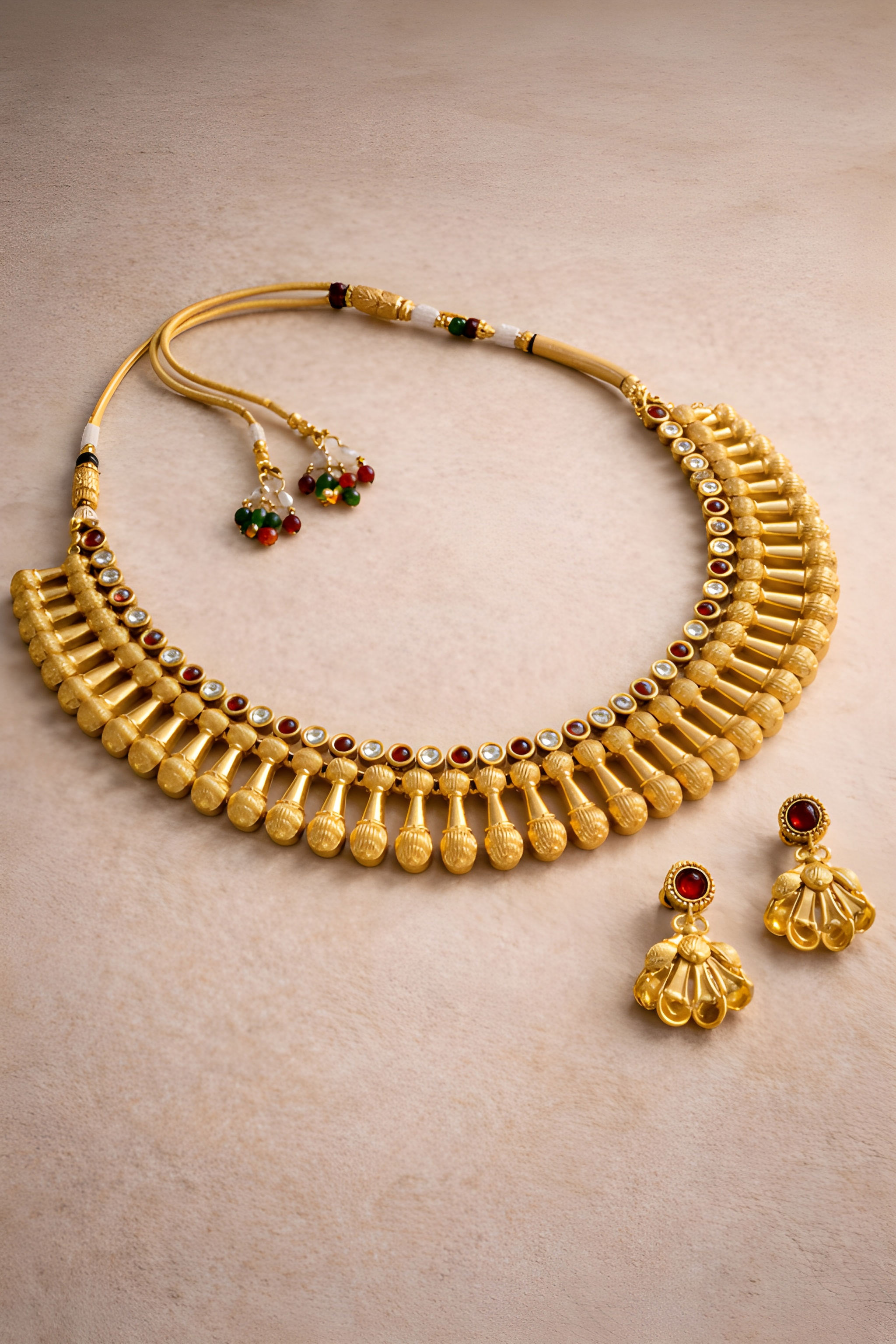 Traditional gold Rani necklace set with red stones and matching jhumka earrings