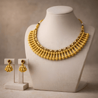 Gold Rani necklace set displayed on bust stand with matching jhumka earrings