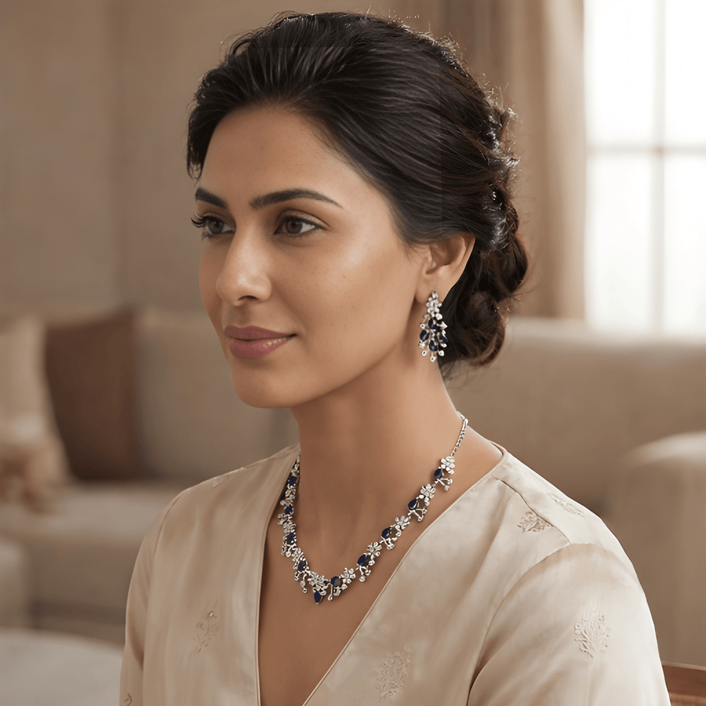 Woman wearing silver sapphire crystal necklace set with matching drop earrings