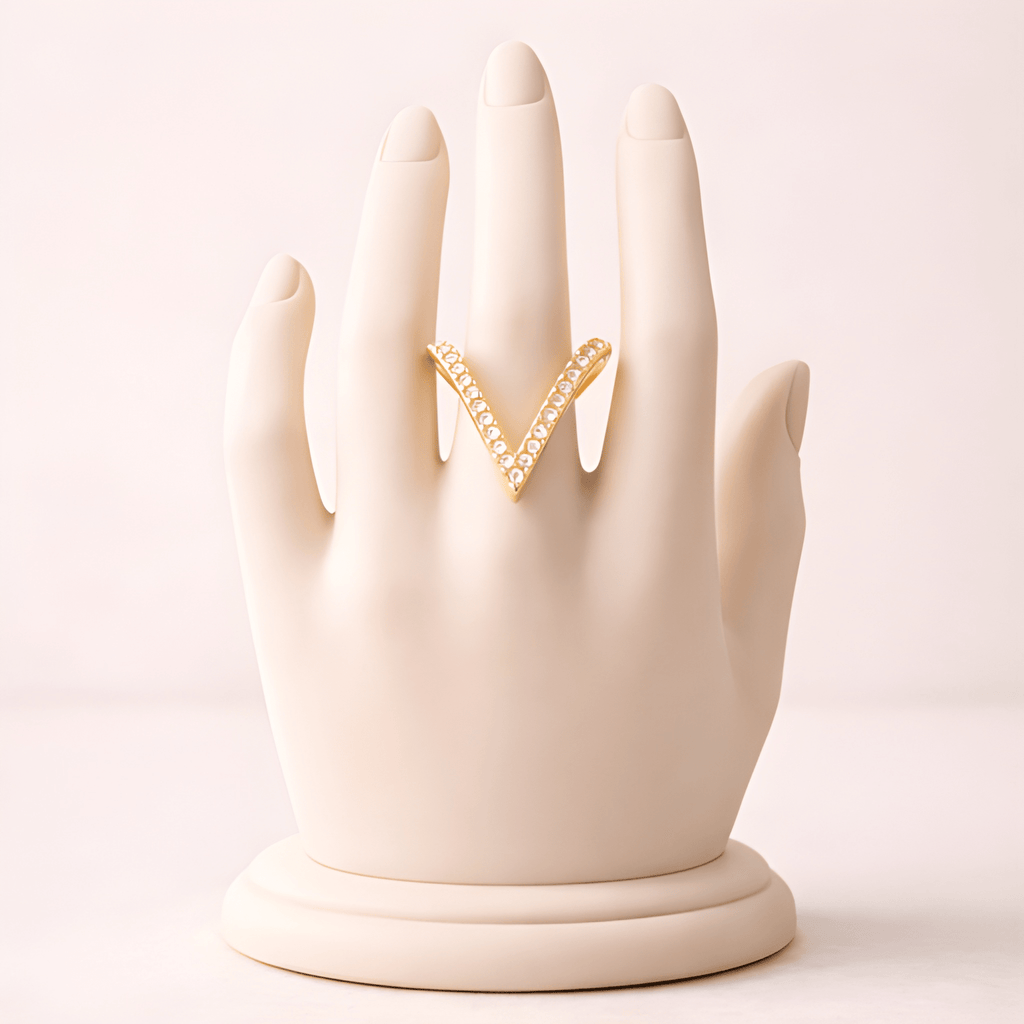 Deep V crystal gold ring displayed on ivory mannequin hand