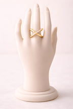 Minimal X crystal gold ring displayed on ivory mannequin hand