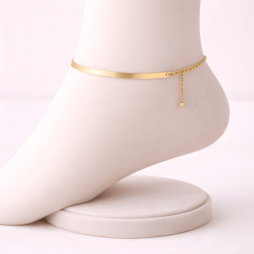 Gold snake chain anklet displayed on ivory mannequin foot