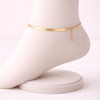 Gold snake chain anklet displayed on ivory mannequin foot