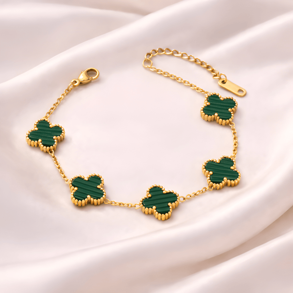 Emerald clover gold bracelet on blush satin