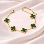 Emerald clover gold bracelet on blush satin