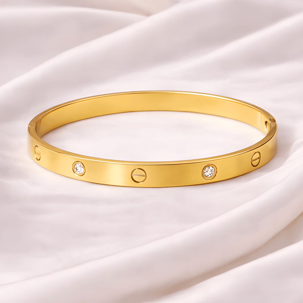 Love screw gold bangle bracelet with crystal accents on ivory silk background | Kayahh Jewels