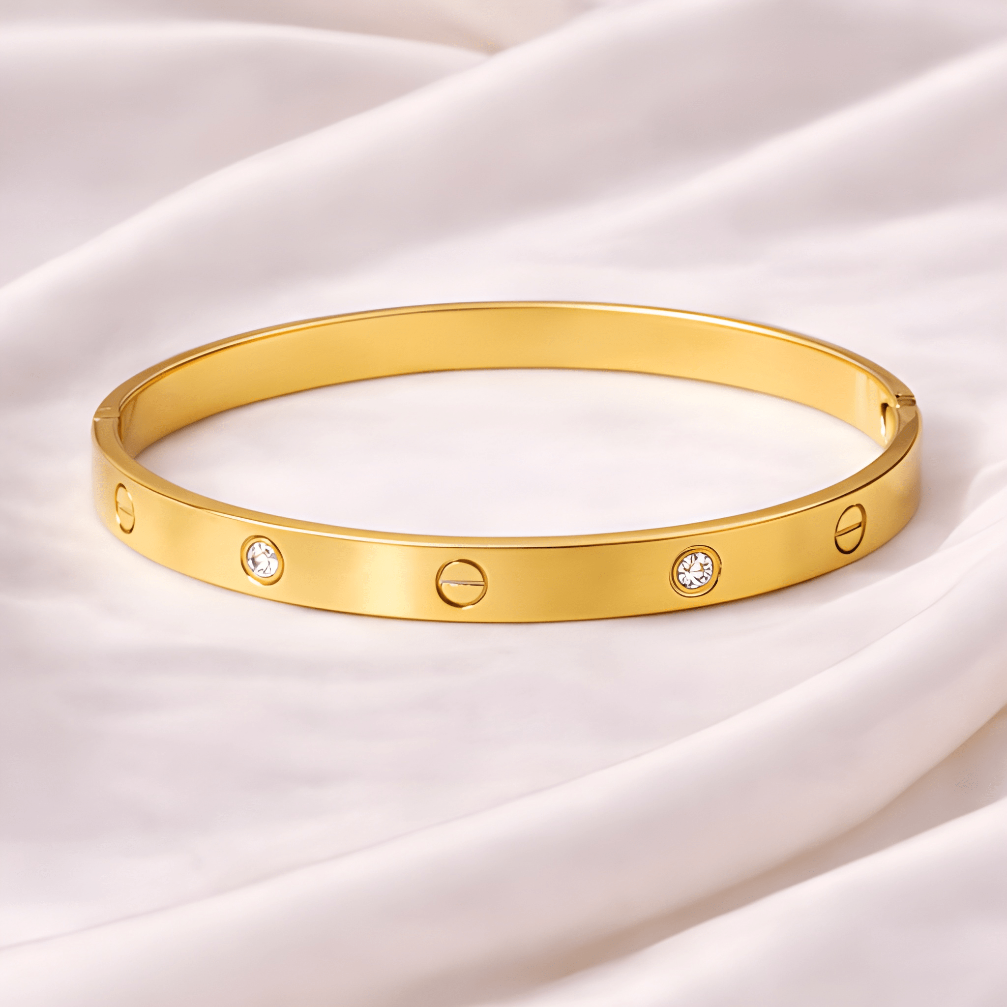 Love screw gold bangle bracelet with crystal accents on ivory silk background | Kayahh Jewels