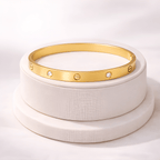 Gold love screw bangle bracelet displayed on ivory jewellery stand | Kayahh Jewels