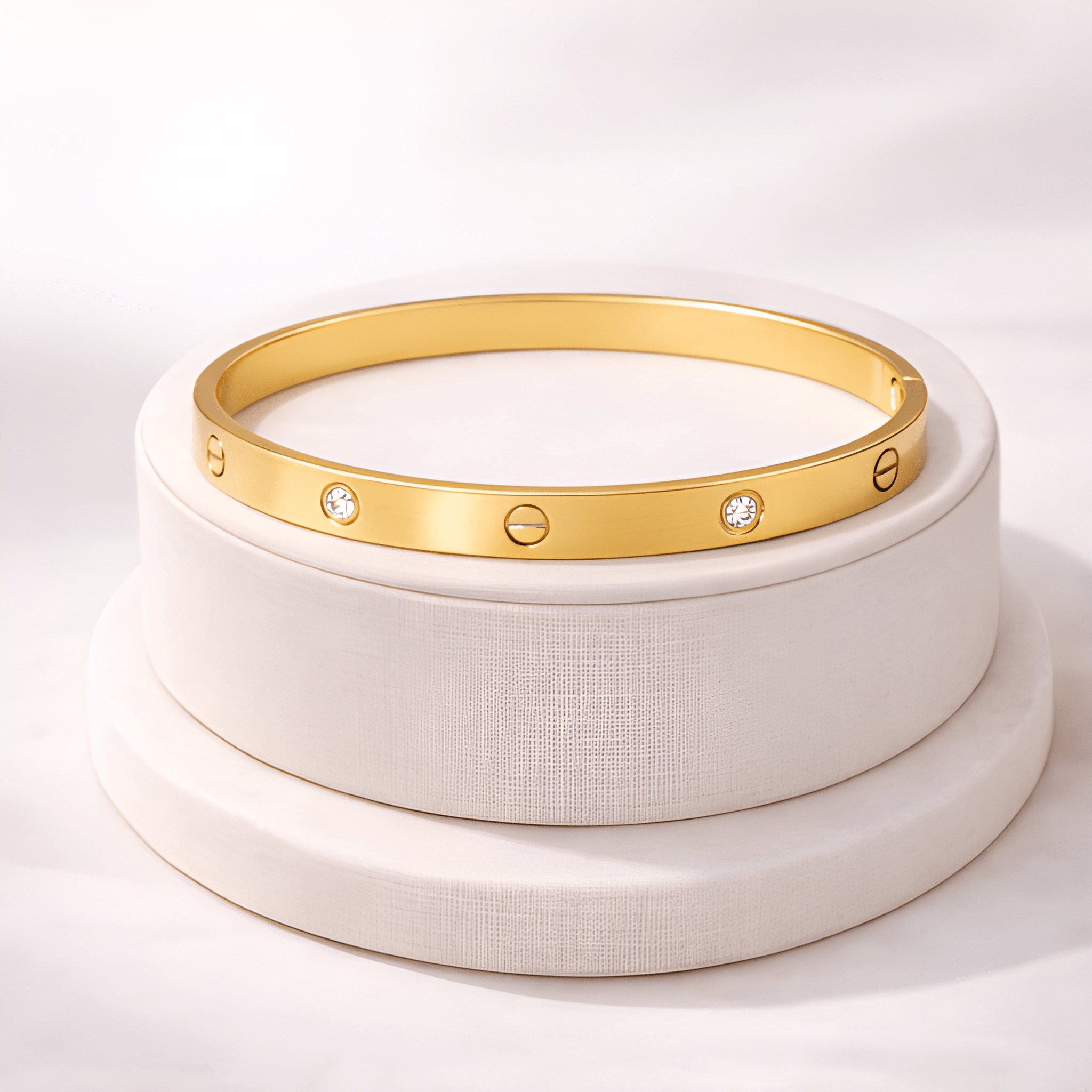 Gold love screw bangle bracelet displayed on ivory jewellery stand | Kayahh Jewels