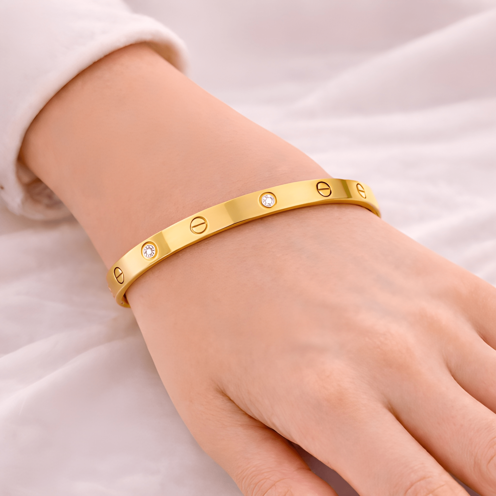 Woman wearing love screw gold bangle bracelet with crystal accents | Kayahh Jewels