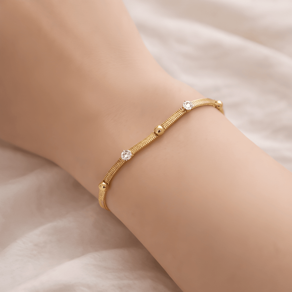 Woman wearing studded chain bracelet with crystal and gold bead details | Kayahh Jewels