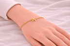 Woman wearing delicate gold bow chain bracelet with bead details | Kayahh Jewels