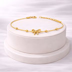 Minimal gold bow bracelet displayed on ivory jewellery stand | Kayahh Jewels