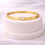 Minimal gold heart crystal bangle bracelet displayed on ivory jewellery stand | Kayahh Jewels