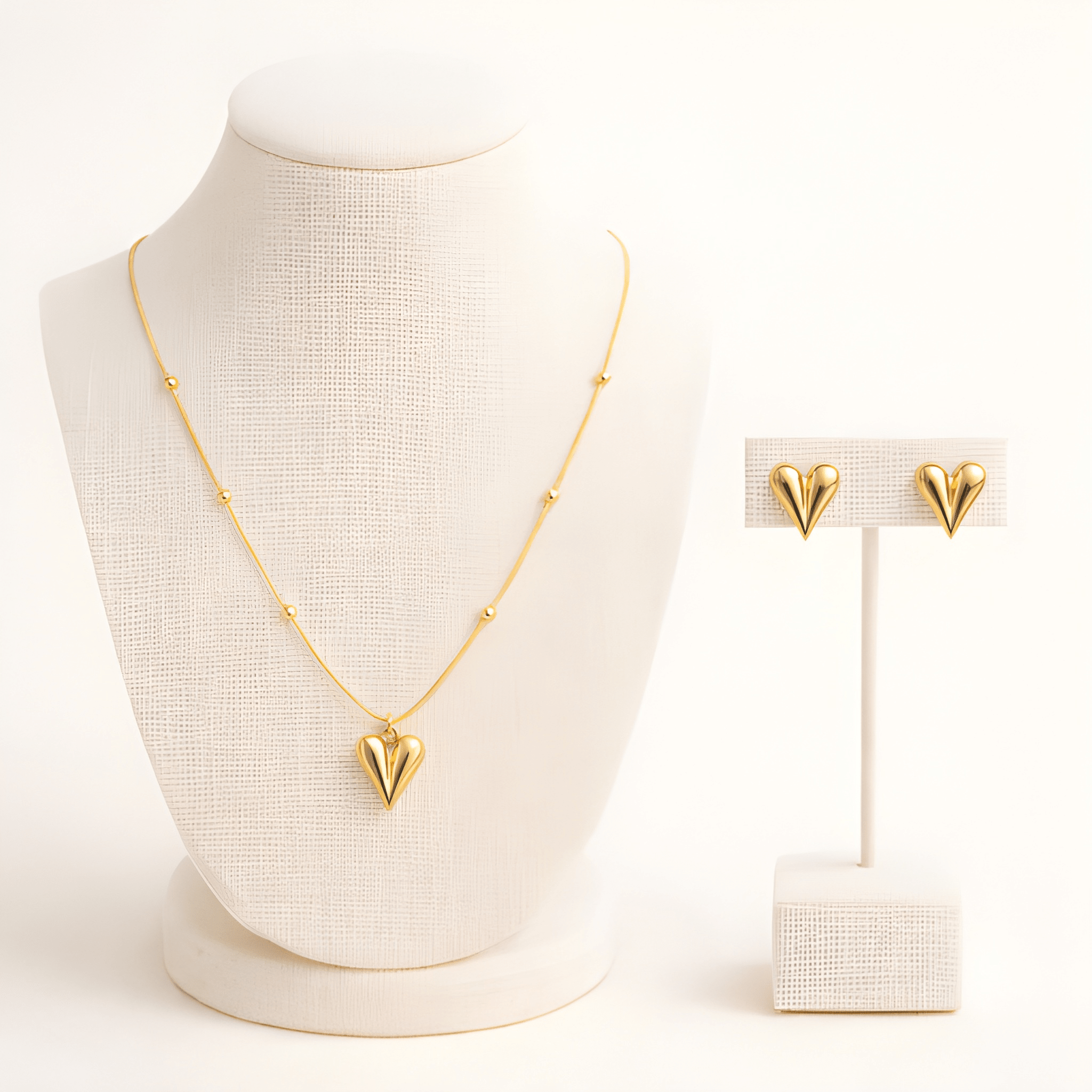 Gold pointed heart pendant necklace set displayed on ivory jewellery stand | Kayahh Jewels