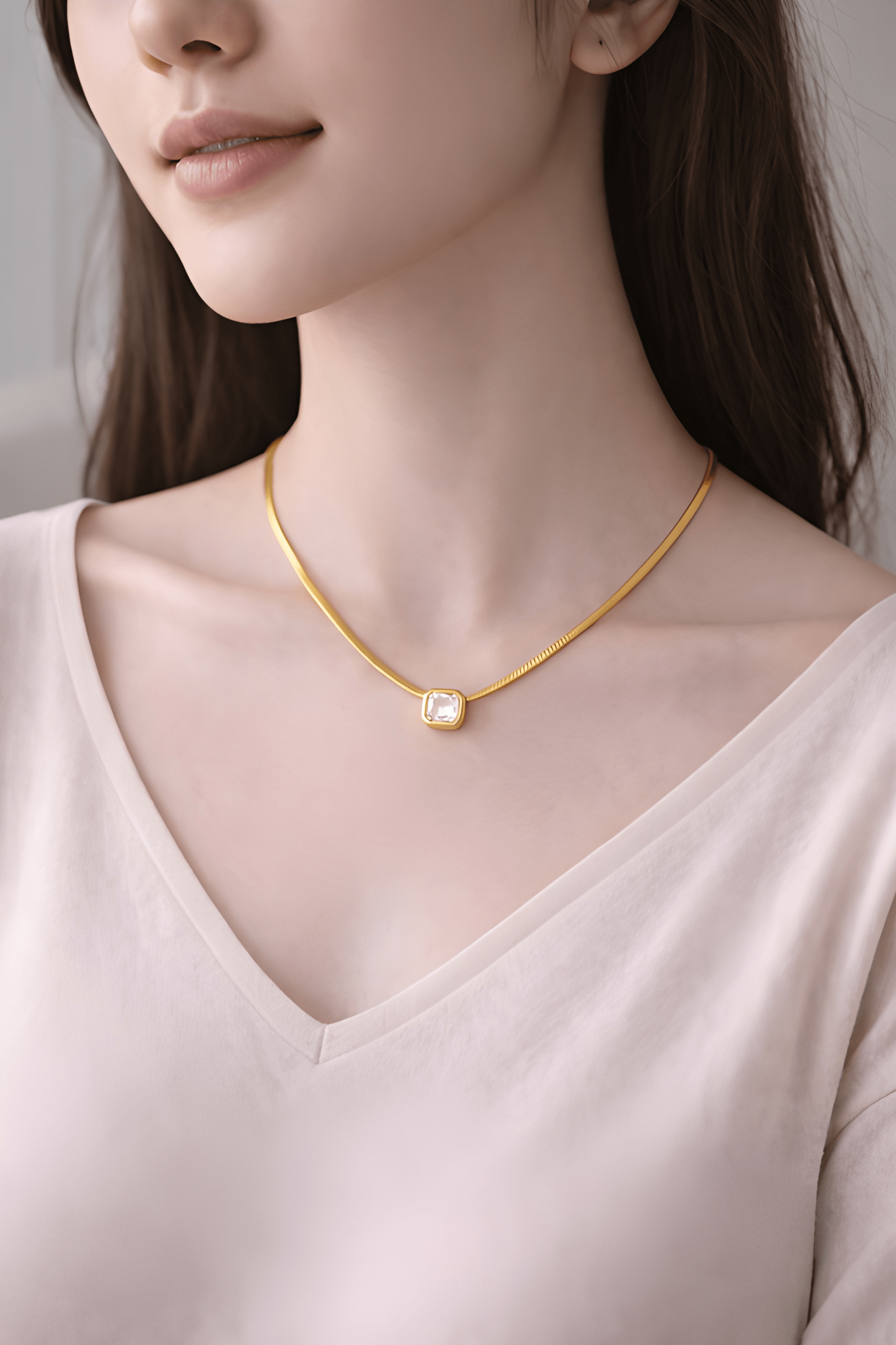 Woman wearing gold rectangle white stone pendant necklace