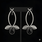 Silver leaf drop earrings displayed on black stand
