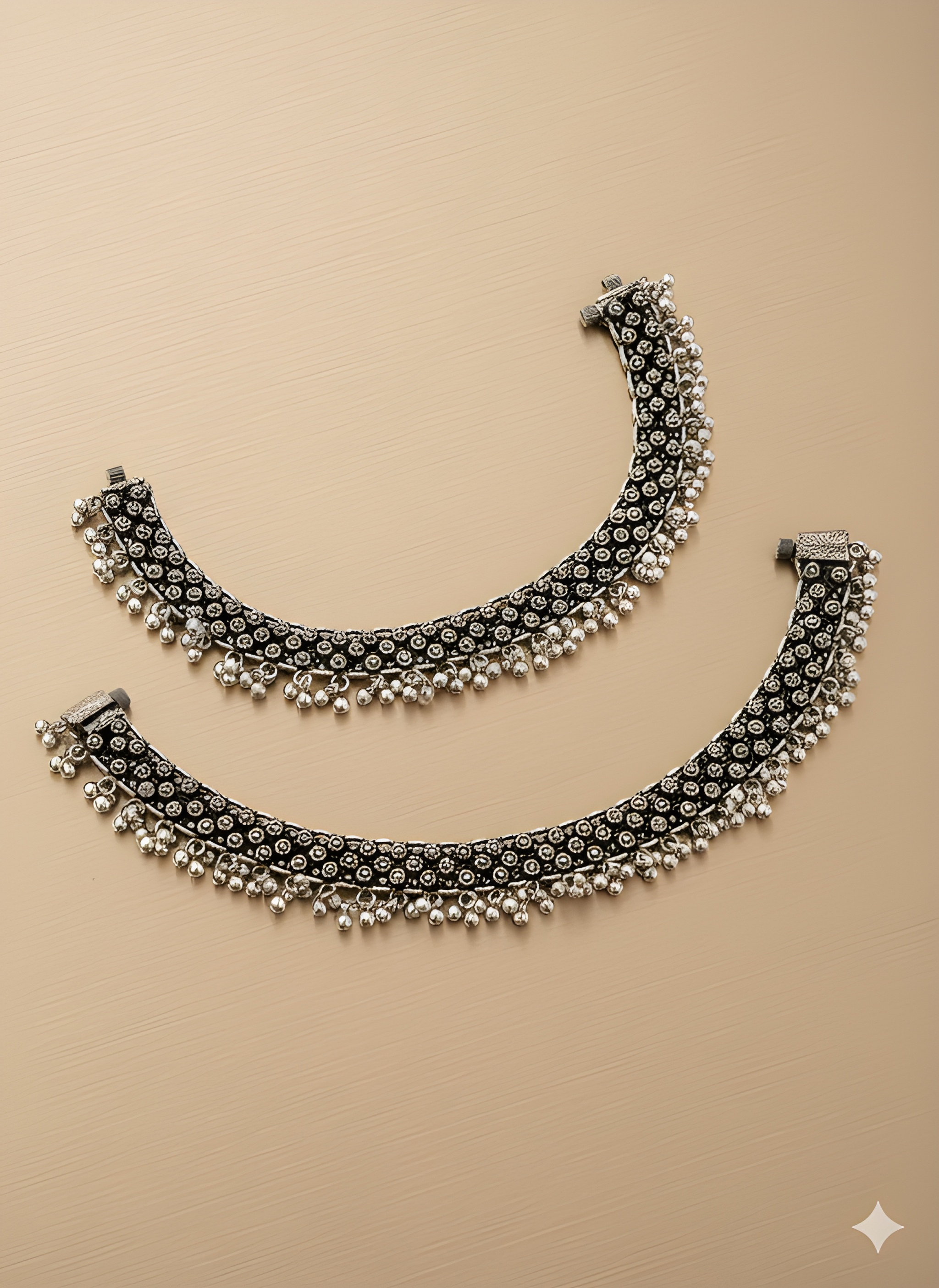 Handcrafted spacing karigari oxidised silver anklet with openwork detailing on golden background

