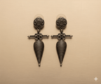 Shell tribal drop earrings with oxidised silver finish on golden background

