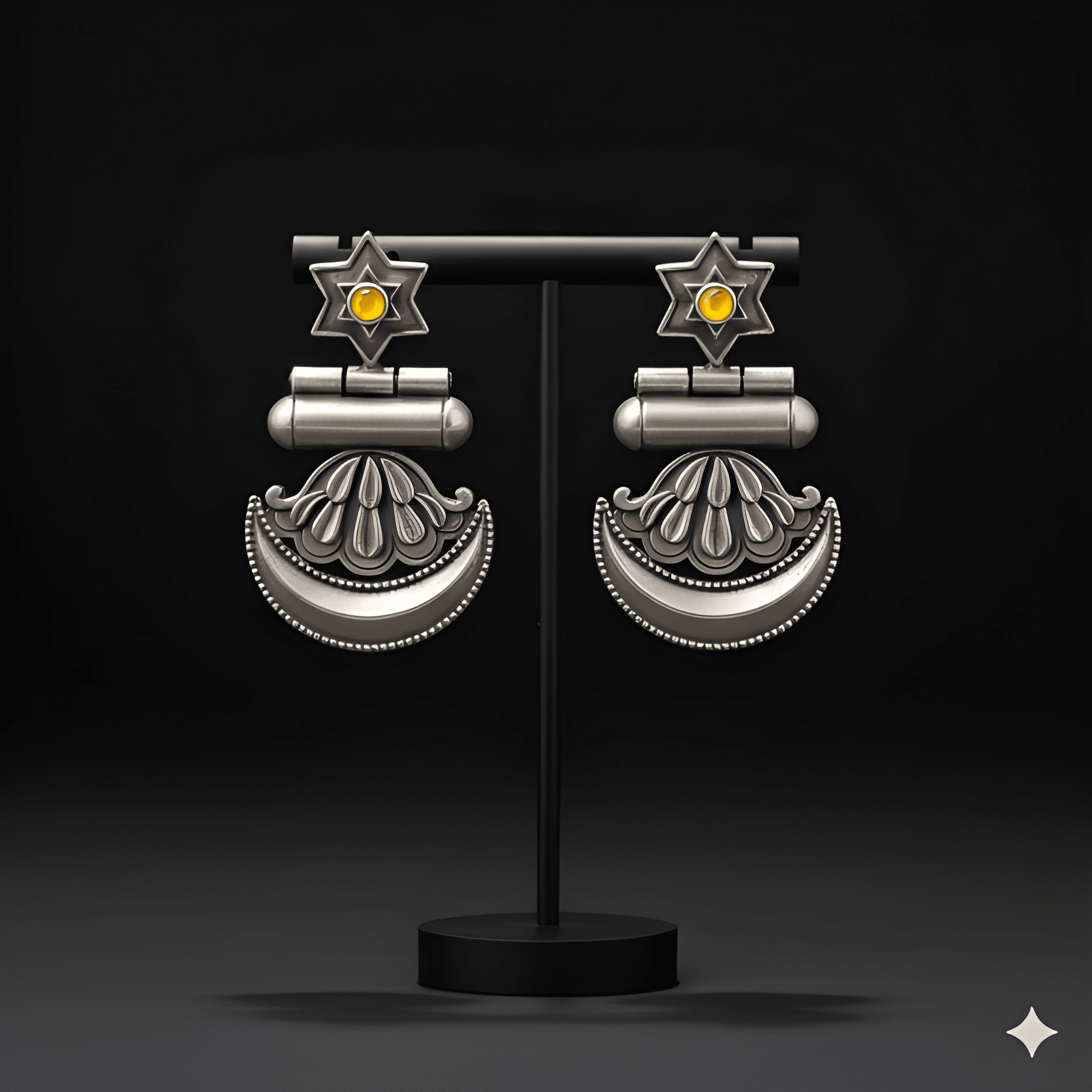 Star crescent dangler earrings displayed on black jewellery stand

