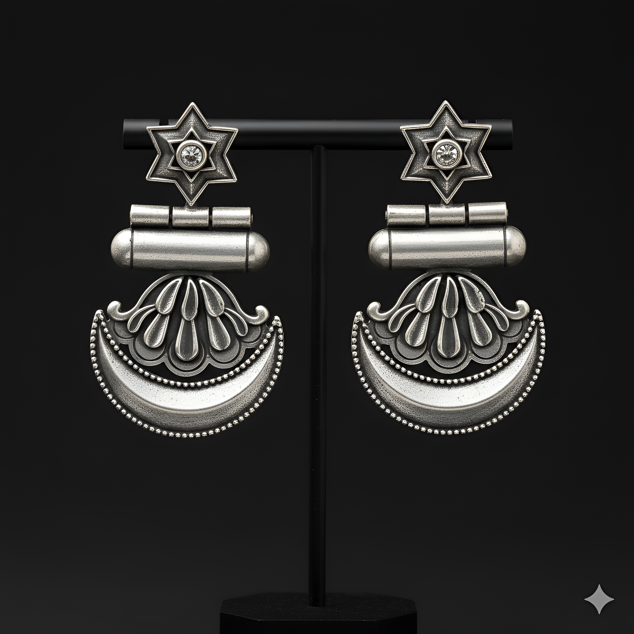 Star crescent dangler earrings displayed on black jewellery stand

