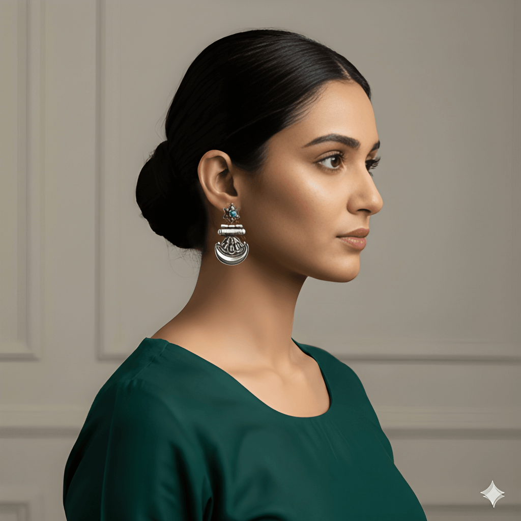 Woman wearing star crescent oxidised silver dangler earrings
