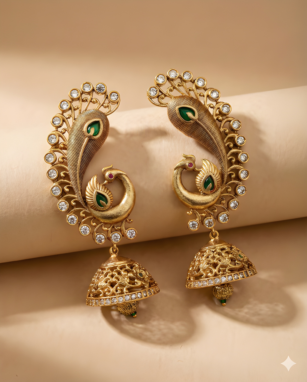 Traditional peacock jhumka earrings with green detailing flat lay