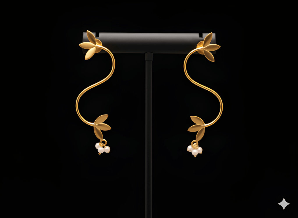 Gold S-shaped vine curve earrings displayed on black stand
