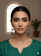 Woman wearing Chandra crescent statement earrings in a bold moon-inspired design
