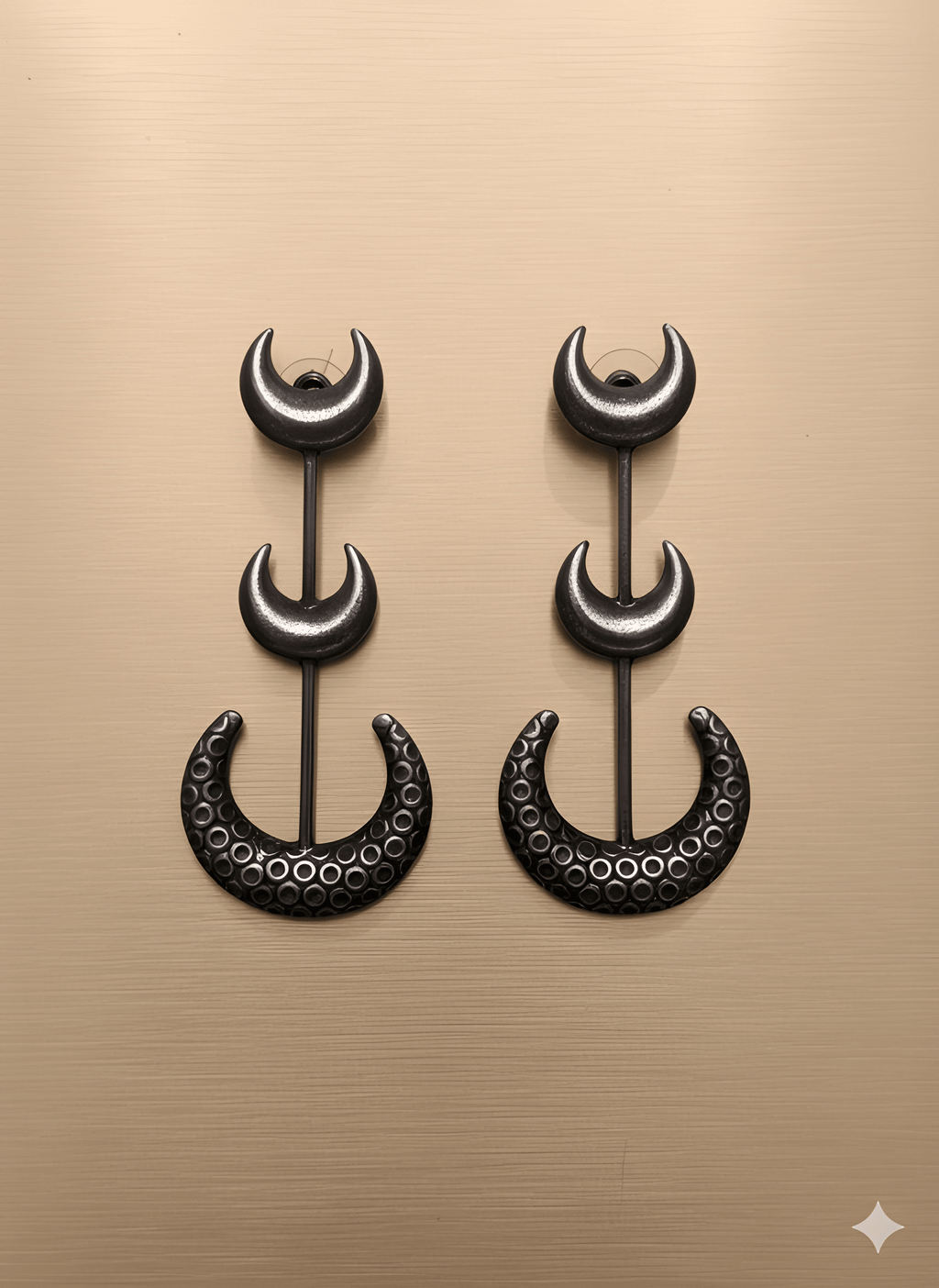 Chandra crescent statement earrings with hammered textured crescent on golden background
