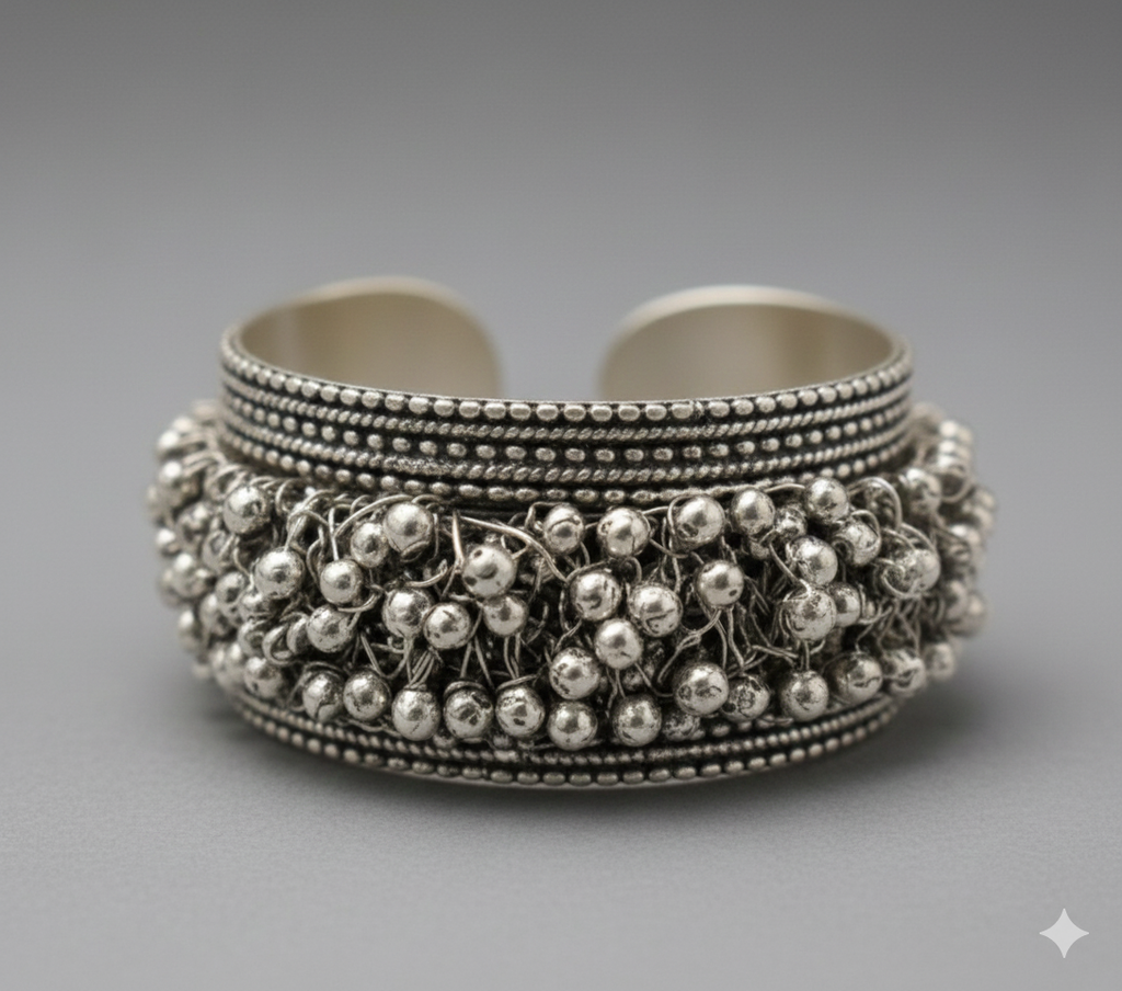 Macro close-up of intricate beaded detailing on handcrafted oxidised silver cuff bracelet
