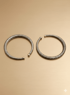 Handcrafted textured brass anklet on golden background
