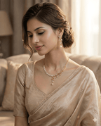 Woman wearing gold leaf crystal necklace set with pearl drop