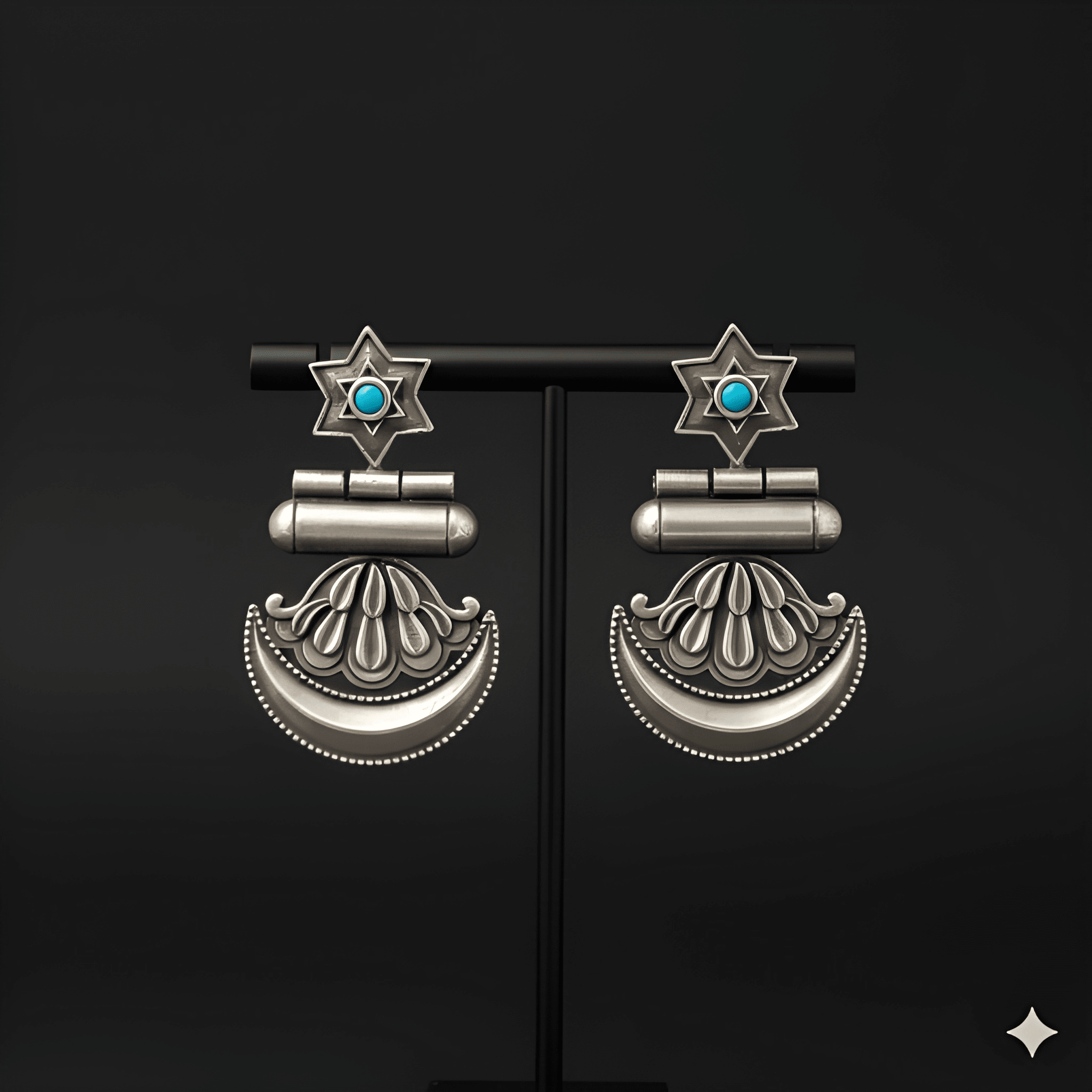 Star crescent dangler earrings displayed on black jewellery stand
