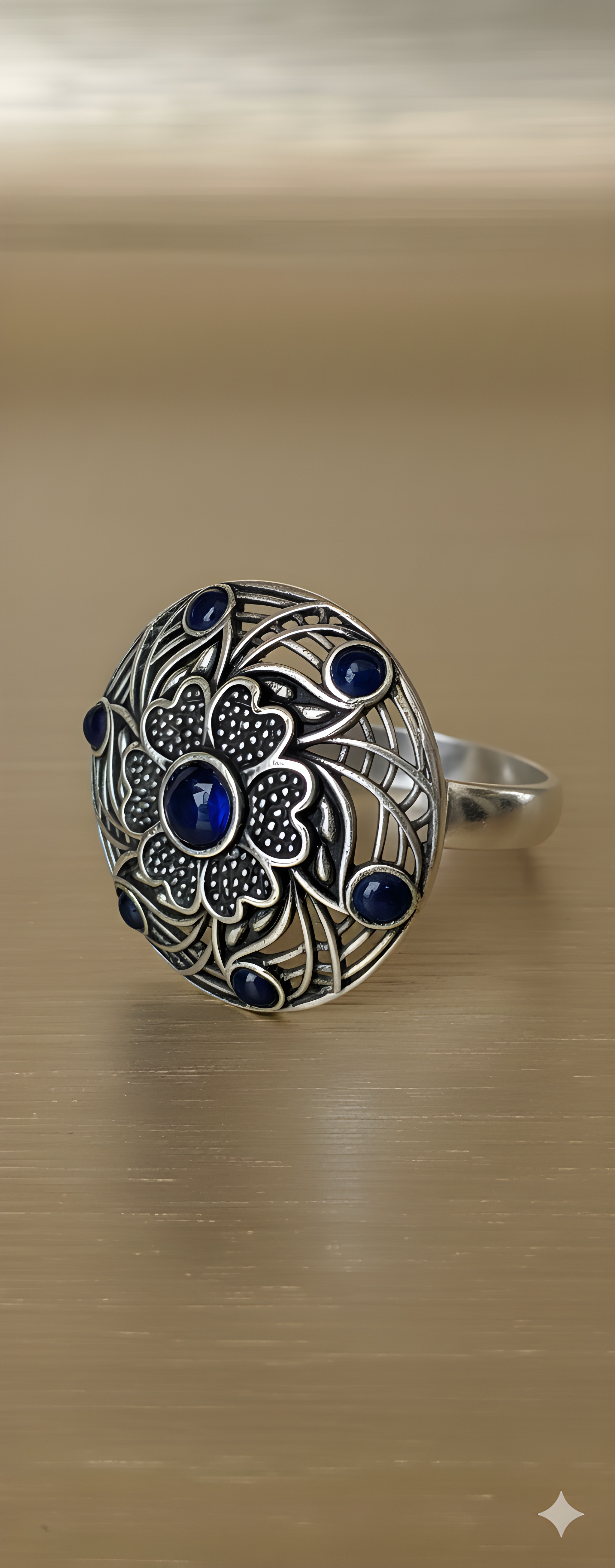 Handcrafted mandala stone ring displayed on golden background