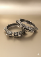 Handcrafted floral engraved oxidised silver cuff bracelet on neutral background
