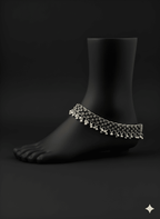 Detailed view of spacing karigari oxidised silver anklet displayed on ankle stand
