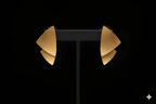 Leaf stud gold earrings displayed on black jewellery stand
