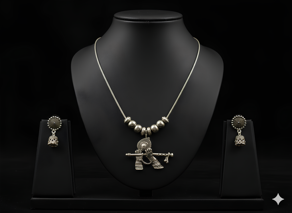 Handcrafted oxidised silver Krishna pendant neckpiece displayed on bust stand