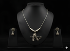 Handcrafted oxidised silver Krishna pendant neckpiece displayed on bust stand