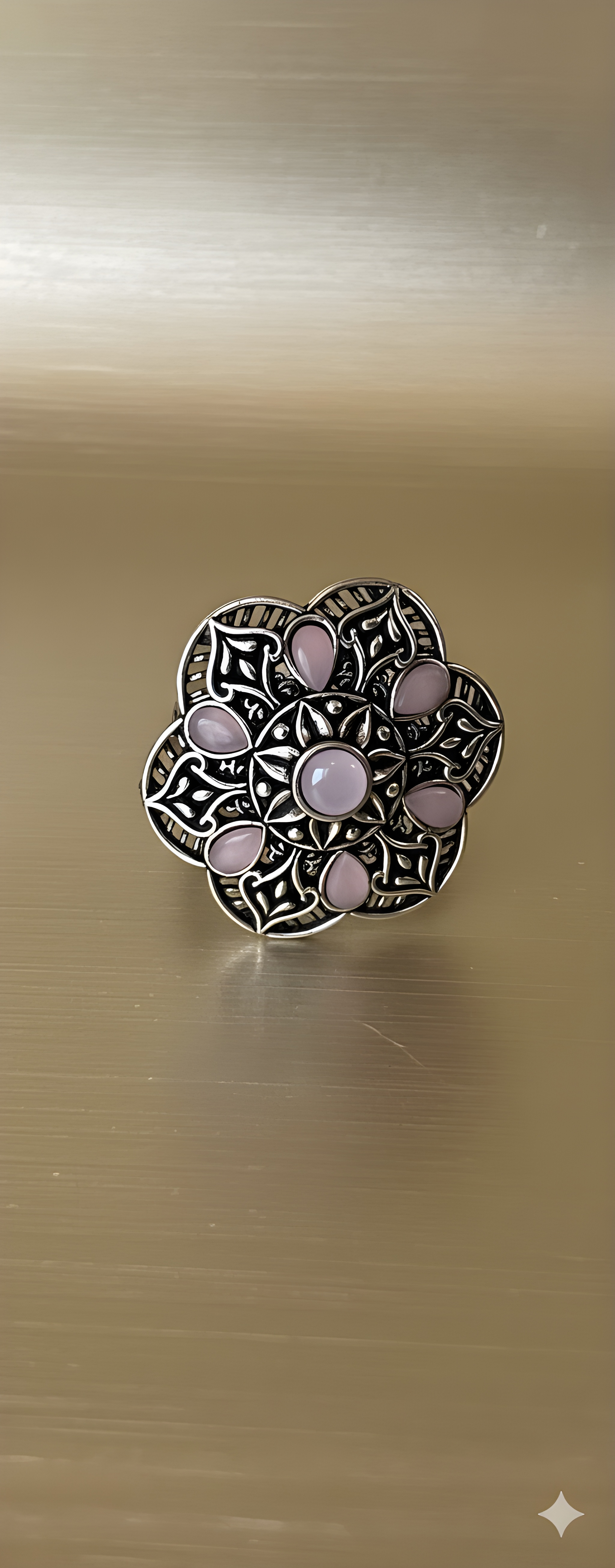 Handcrafted mandala stone ring displayed on golden background