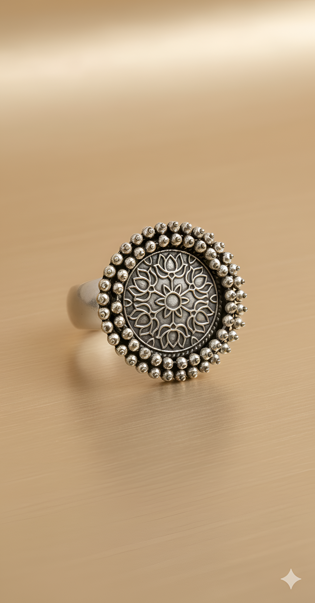 Pearl detail oxidised silver statement ring on golden background