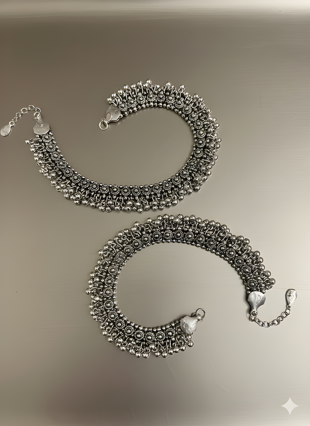 Handcrafted oxidised silver ghungroo karigari anklet displayed on golden background
