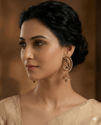 Woman wearing peacock jhumka earrings